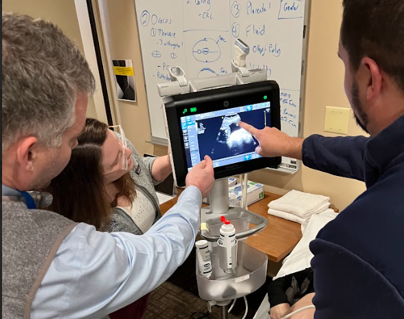 Sonographers at Ultrasound Event reviewing ultrasound image